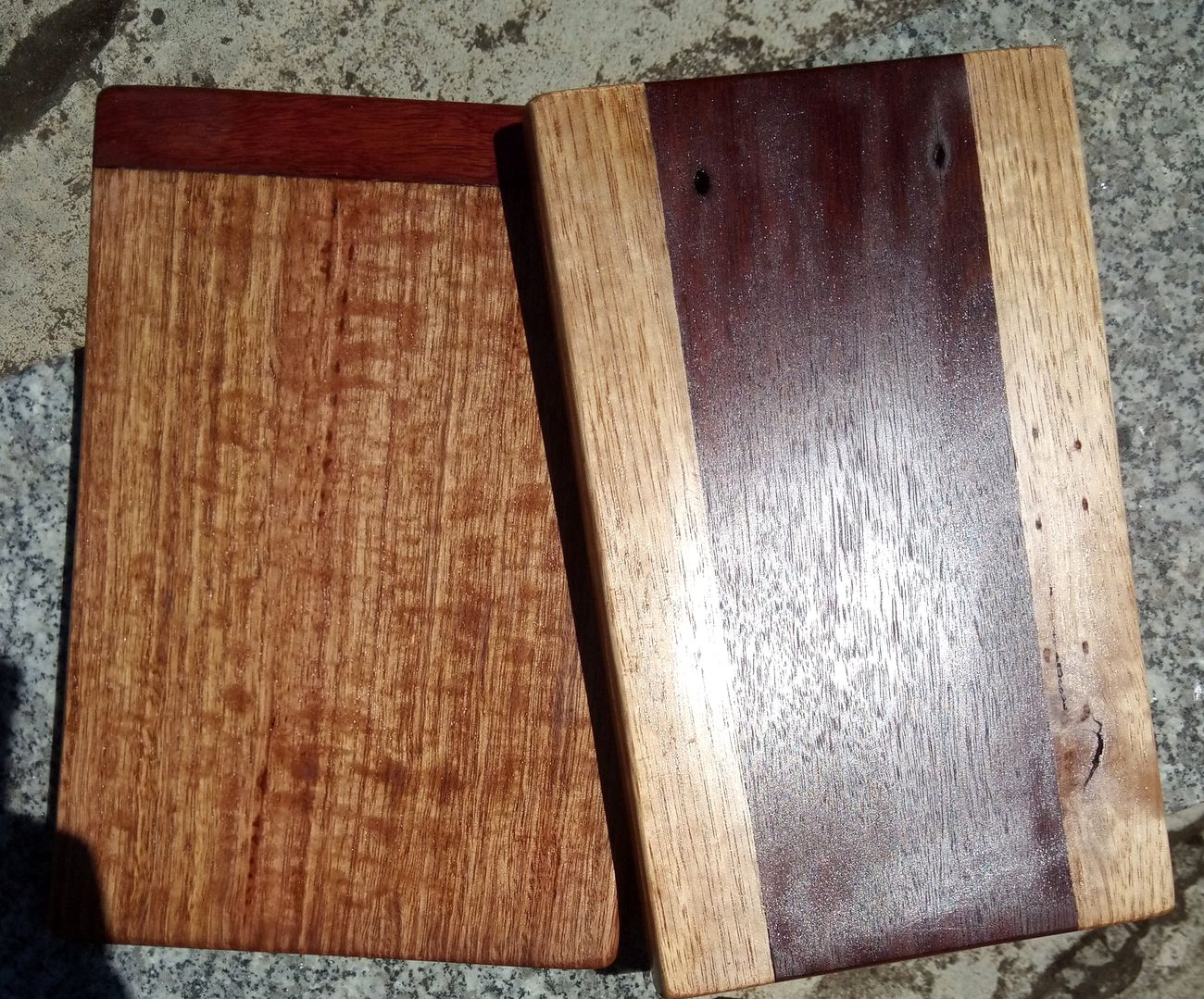 Two hand-made timber chopping boards, one reddish and one with a dark centre stripe