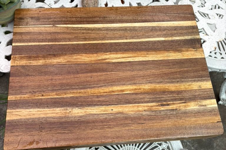 A timber chopping board after restoration: clean, even timber with a smooth finish