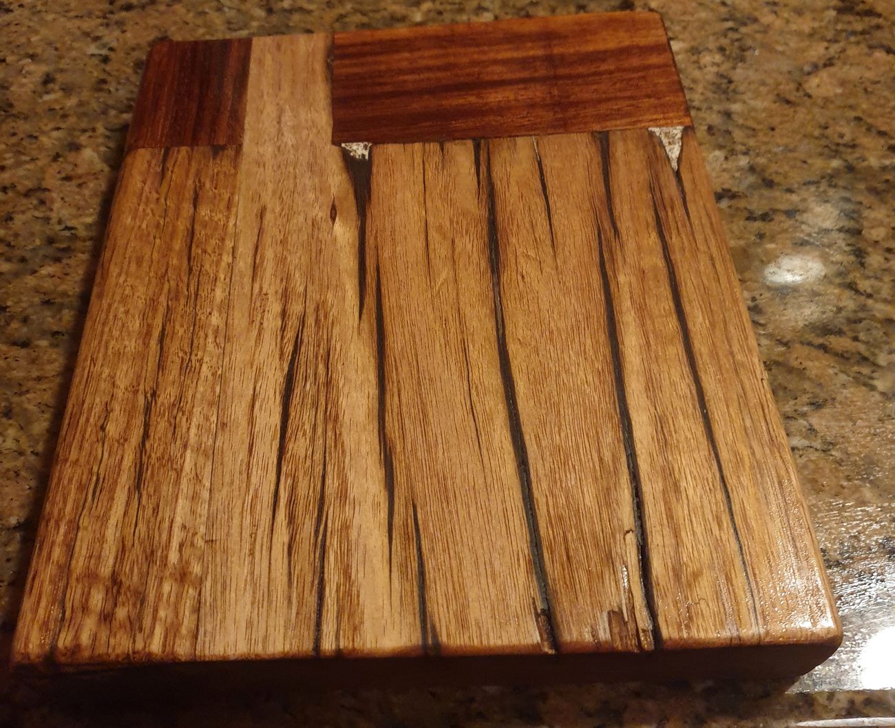 A restored timber chopping board on a granite bench